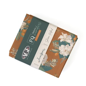 May include: A fabric quarter bundle featuring a floral print with white flowers and green leaves on a rust-colored background. The fabric is labeled "Juniper" and "FQ fabric wonders" by Sharon Holland.