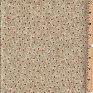 May include: Beige fabric with a repeating pattern of small red stars and green leafy vines.