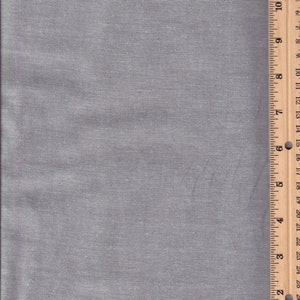 May include: A close-up of a gray fabric with a ruler measuring 30 inches. The fabric has a subtle texture and a slightly sheen finish.