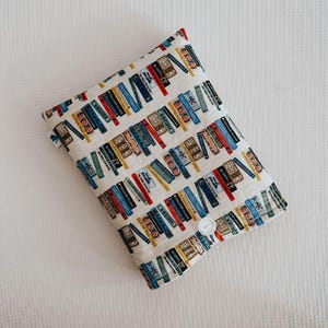 Protège-livre, couverture rembourrée en coton de marque et fermeture à bouton pour protéger votre livre actuel que vous pourrez lire où que vous soyez !