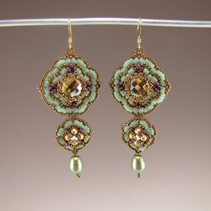 May include: A pair of gold-tone earrings with green and brown beads. The earrings feature a large, faceted, gold-toned bead in the centre of each earring.