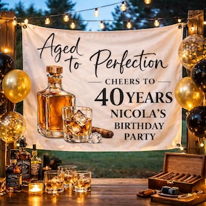 Könnte beinhalten: Banner mit der Aufschrift "Aged to Perfection" mit Whiskyflasche, Glas mit Eiswürfeln und Zigarre. Der Bannertext lautet "Cheers to 40 Years, Nicola's Birthday Party". Goldene und schwarze Ballons und Lichterketten.