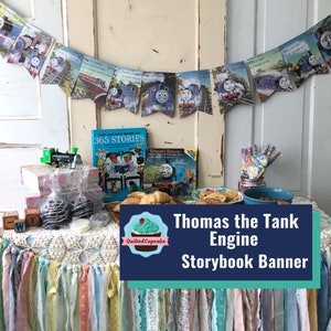 May include: A banner made of pages from a Thomas the Tank Engine storybook, with images of the blue train. The banner is displayed above a table with books, treats, and a toy train. The text "Thomas the Tank Engine Storybook Banner" is visible.