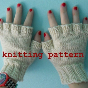 May include: A pair of white knitted fingerless gloves with a ribbed cuff. The gloves are shown on a person's hands with red nail polish. The text "knitting pattern" is written in red letters below the gloves.