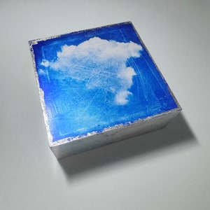 Small blue and white cloud artwork for gifting and small spaces, shelf