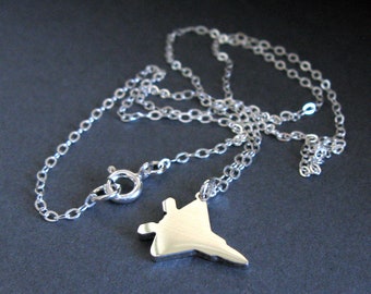 May include: A silver chain necklace with a silver pendant shaped like a fighter jet.