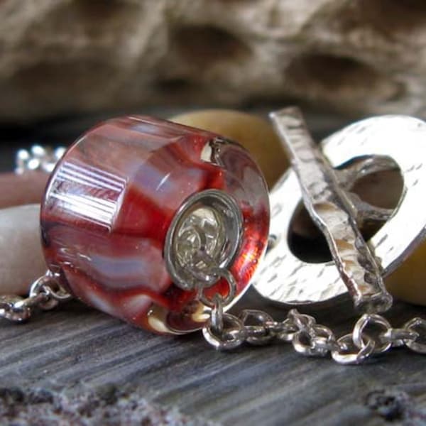 Pleasure Works. Sterling silver lined boro glass bead necklace. Red, salmon and brick. Handmade toggle clasp and quality 2mm rolo chain.