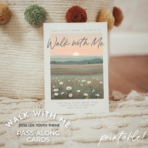 May include: A rectangular card with the text "Walk with Me" and "2026 LDS Youth Theme". The card features a landscape painting of a field with daisies, mountains, and a sunset. The words "Pass-Along Cards" and "printable!" are also present.
