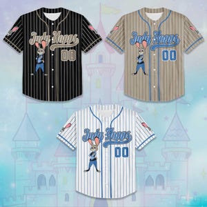 May include: Three baseball jerseys featuring the character Judy Hopps from Zootopia. The jerseys are black, tan, and white with vertical stripes. Each jersey has the name "Judy Hopps" and the number "00" on the front, along with an image of Judy.