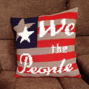 May include: Crocheted pillow with an American flag design and the words "We the People" in white lettering.