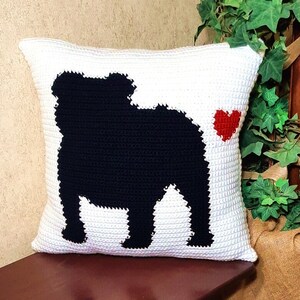 May include: White crocheted pillow with a black silhouette of a bulldog and a red heart.