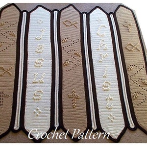 May include: A crocheted pattern featuring a series of vertical panels in shades of beige, cream, and brown. Each panel has a dark brown border and is adorned with religious symbols and text. The words "Crochet Pattern" are at the bottom.