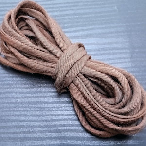 May include: A coil of brown elastic cord, ideal for crafting projects.