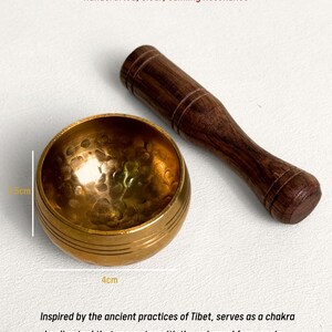May include: A Tibetan mini singing bowl, 4 cm in diameter and 2.5 cm high, with a wooden mallet. The bowl is gold-colored with a hammered texture. Text on the image reads: "Tibetan Mini Singing Bowl, Handcrafted, Clear, Calming Resonance."
