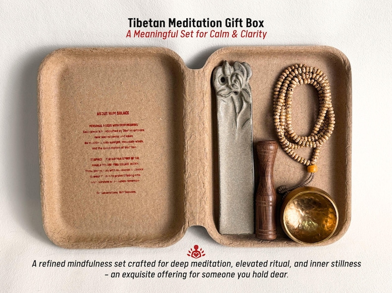 May include: A Tibetan Meditation Gift Box set in a natural-toned container. The set includes a prayer bead necklace, a carved stone, a wooden item, and a brass bowl. Text on the box reads "A Meaningful Set for Calm & Clarity."