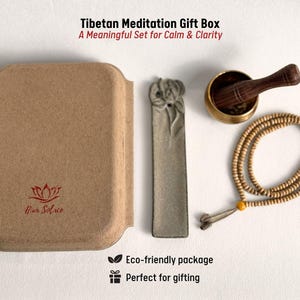 May include: A Tibetan Meditation Gift Box set includes a brown box, a gray incense holder, a brass singing bowl with a wooden striker, and a beaded mala. The box has the text "Hur Solue" and "Tibetan Meditation Gift Box". The set is an eco-friendly package.