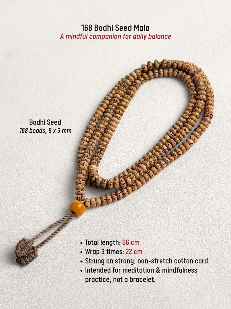 May include: A Bodhi Seed Mala necklace with 168 beads, each 5 x 3 mm. The total length is 26 inches. The necklace is strung on a strong, non-stretch cotton cord. The text reads: "A mindful companion for daily balance."