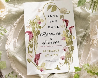 May include: A white rectangular Save the Date card featuring a botanical illustration of calla lilies, orchids, and hanging greenery. The text reads: Save the Date, Rainata & Dareel are getting married, 01.10.2027 at 6 PM, formal invitation to follow.
