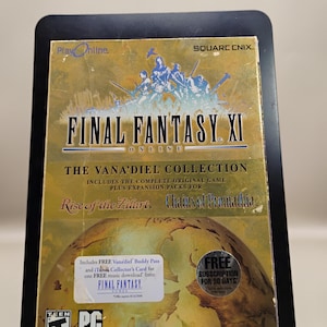 May include: Final Fantasy XI: The Vana'diel Collection game box. The box is gold with blue and white text and graphics. Includes the complete original game and expansion packs. Features the text "PlayOnline" and "SQUARE ENIX". Includes a free subscription for 30 days.