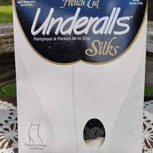 May include: A rectangular product packaging box for French Cut Underalls Silks pantyhose and panties all in one. The box is white with a large dark blue header featuring the brand name, style information, and a small cutout showing the black fabric.