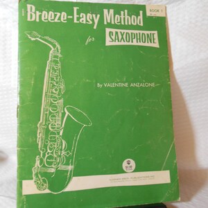 May include: Green book cover with the title "Breeze-Easy Method for Saxophone" in white text. The book is by Valentine Anzalone and has a drawing of a saxophone on the cover.
