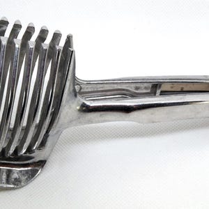 metal slicer safety tong configuration use for slicing eggs onions tomatoes etc