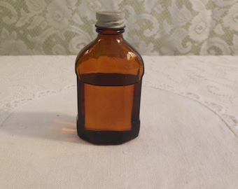 vintage medicine bottle with liquid contents that smells minty - circa 1960s