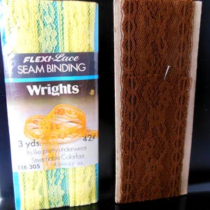 May include: Two spools of seam binding. One is yellow and turquoise, labeled "FLEXI-Lace SEAM BINDING" by Wrights. The other is brown lace. The yellow spool reads "3 yds." and "Stretchable Colorfast".