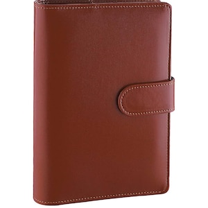 May include: A brown leather bound planner with a flap closure and a stitched design.