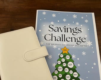 May include: A white A6 binder with a magnetic closure tab sits next to a Savings Challenge for Holidays and Special Occasions paper sheet featuring a green Christmas tree graphic with various dollar amount circles.