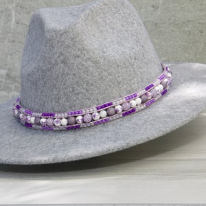 May include: A gray felt fedora hat with a purple and white beaded band.