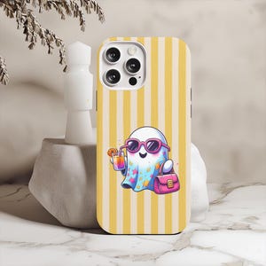 May include: Phone case with a yellow and white striped design. It features a cartoon ghost wearing pink sunglasses, holding a drink and a pink handbag. The ghost is wearing a blue cape with stars.