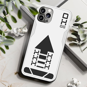 May include: White phone case with a black and white graphic of a building with an arrow pointing up. The case has the text "GG 222" on the side.