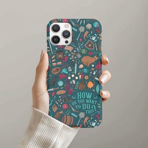 May include: Teal phone case with a repeating pattern of fantasy-themed illustrations, including a cat, shield, and musical instrument. The case features the text "HOW DO YOU WANT TO DO THIS?"