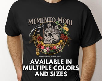 May include: Black t-shirt with a skull and floral design. The text "Memento Mori" and "Let us postpone nothing" is printed on the shirt. The text "Available in multiple colors and sizes" is also printed on the shirt.