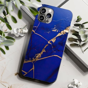 May include: A royal blue phone case with a gold vein design. The case has a glossy finish and a three-lens camera cutout. The design resembles a cracked stone or marble pattern, adding a touch of elegance to the phone accessory.