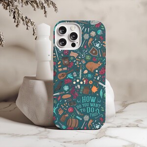 May include: Teal phone case with a whimsical pattern of fantasy-themed illustrations, including a cat, shield, and dice. The case features the text "HOW DO YOU WANT TO DO THIS?" in white. The case has a camera cutout.
