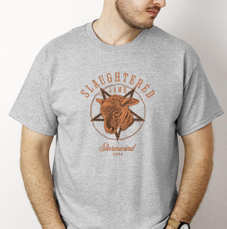 May include: A gray t-shirt featuring a brown graphic of a lamb's head inside a star and barbed wire design. The text "Slaughtered Lamb" arches above the image, with "Stormwind 2004" below.