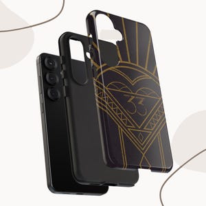 May include: Black phone case with a gold art deco design featuring a heart, geometric shapes, and the number 33. The case is shown in three separate pieces, with the phone visible.
