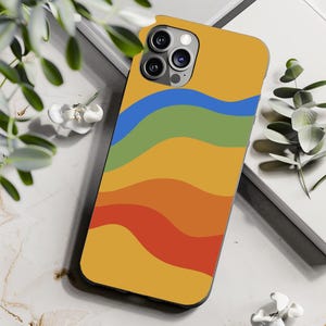 May include: A yellow phone case with a colorful abstract design of wavy lines in blue, green, orange, and red.