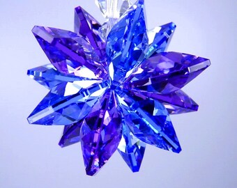 May include: A blue and purple crystal starburst ornament with a clear crystal hanging loop.