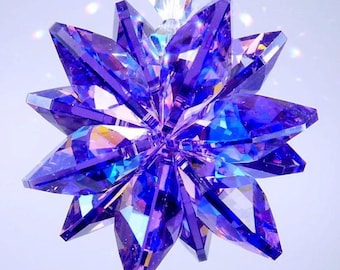 May include: A purple crystal starburst ornament with iridescent facets. The starburst is hanging from a clear crystal string.
