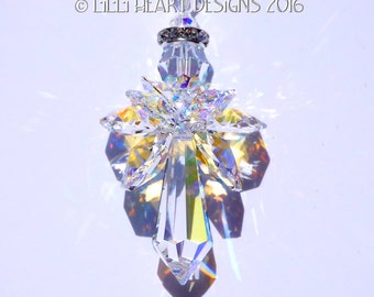 May include: A crystal angel suncatcher with a clear, faceted body and iridescent wings. The angel is suspended from a silver-toned metal ring.