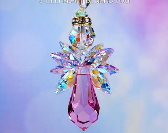 May include: A pink crystal angel suncatcher with iridescent wings and a clear crystal bead at the top.  © Lilli Heart Designs 2021
