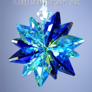 May include: A multi-faceted, star-shaped ornament with a clear, faceted crystal at the top. The ornament is primarily blue and turquoise, with a clear crystal at the top. The text "&copy; LILLI HEART DESIGNS 2013" is visible at the top.