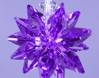 May include: A purple crystal star ornament with a clear crystal hanging from the top.