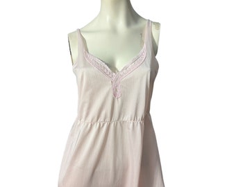 May include: A pink sleeveless slip dress with a delicate lace trim around the neckline.