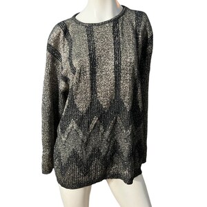 May include: A black and silver sweater with a geometric pattern.