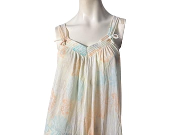 May include: A white sleeveless nightgown with a floral print in shades of peach, blue, and green. The gown has a V-neckline and adjustable straps.