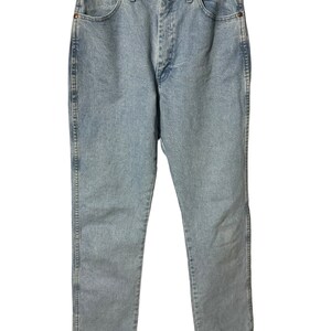 May include: Light blue denim jeans with a straight leg fit. The jeans have a classic five-pocket style and a button fly.